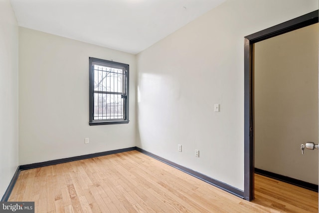 spare room with light hardwood / wood-style flooring