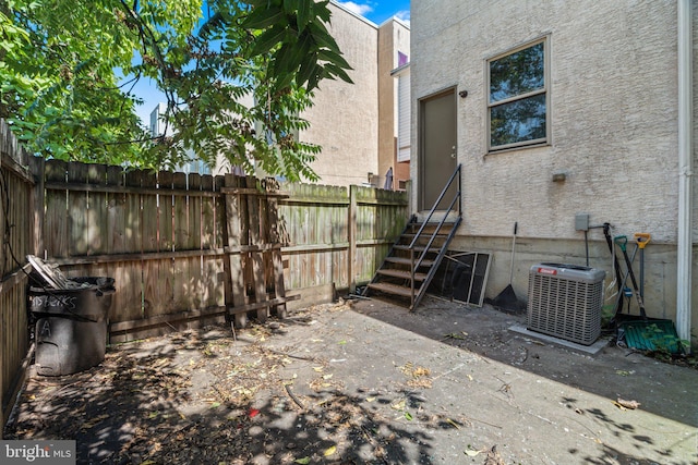 view of yard with cooling unit and a patio area