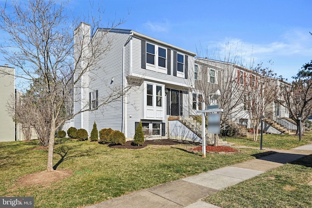 townhome / multi-family property featuring a chimney and a front lawn