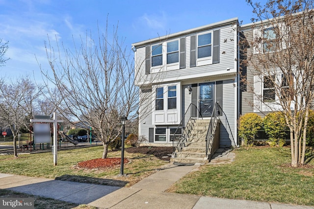 townhome / multi-family property featuring a playground and a front yard