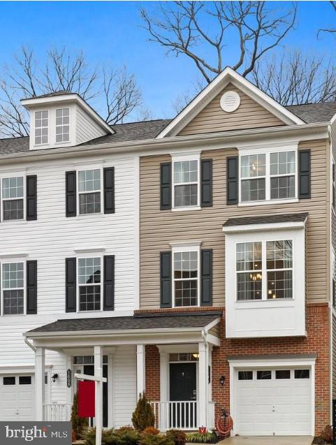 view of front of home with a garage and a porch