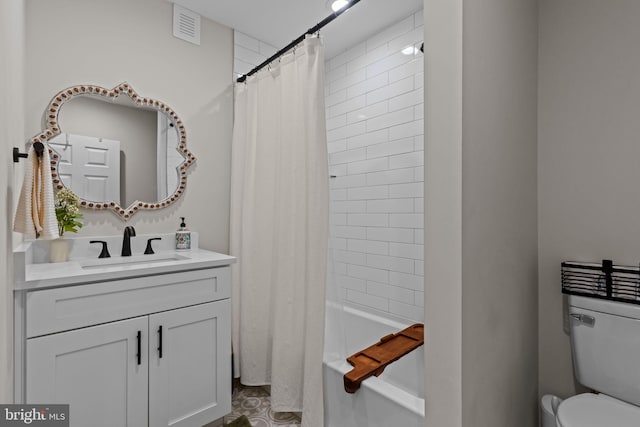 full bathroom with vanity, shower / bath combination with curtain, and toilet