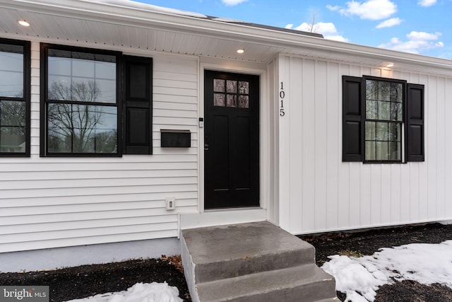 view of snow covered property entrance