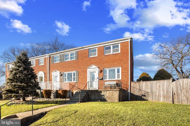 view of front of property featuring a front lawn and brick siding