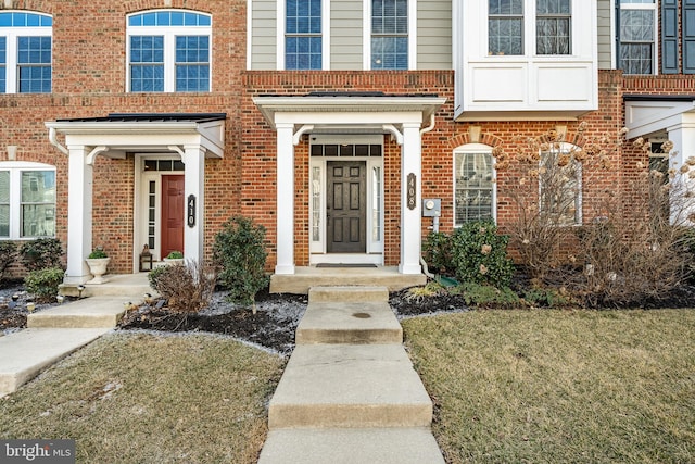 entrance to property with a lawn