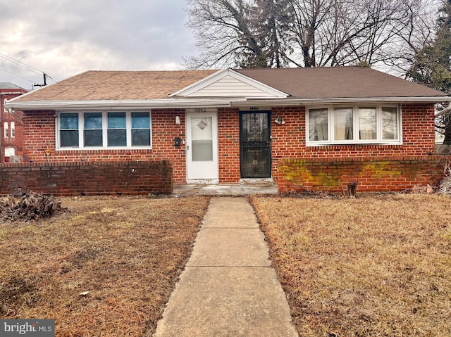 bungalow-style home with a front yard