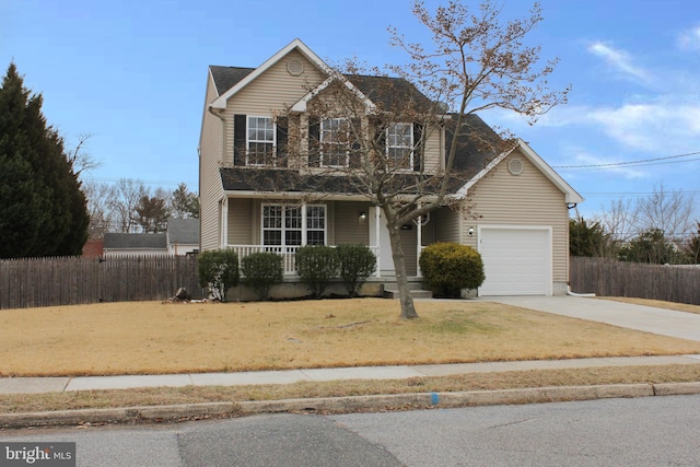 view of property with a garage, a front yard, and a porch