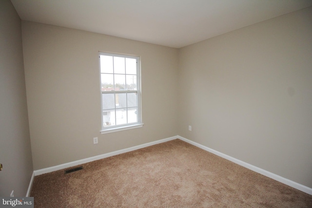 unfurnished room featuring carpet