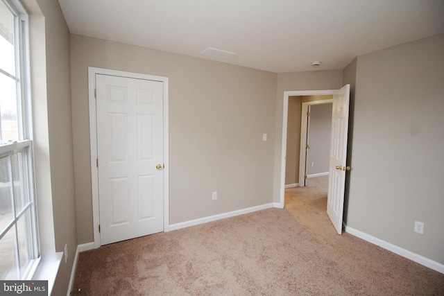 unfurnished bedroom featuring light colored carpet