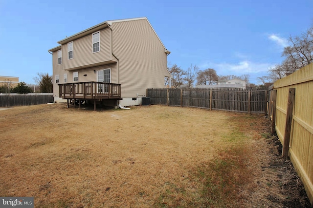 back of property featuring cooling unit, a yard, and a deck