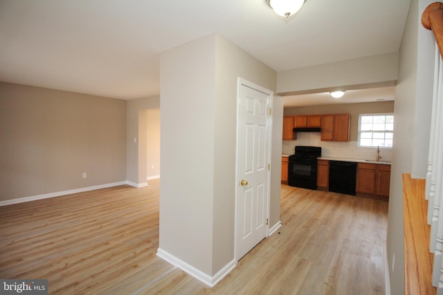 hall featuring sink and light hardwood / wood-style floors