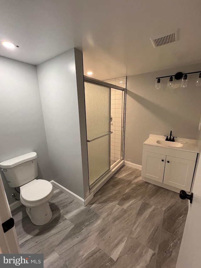 bathroom featuring walk in shower, vanity, and toilet