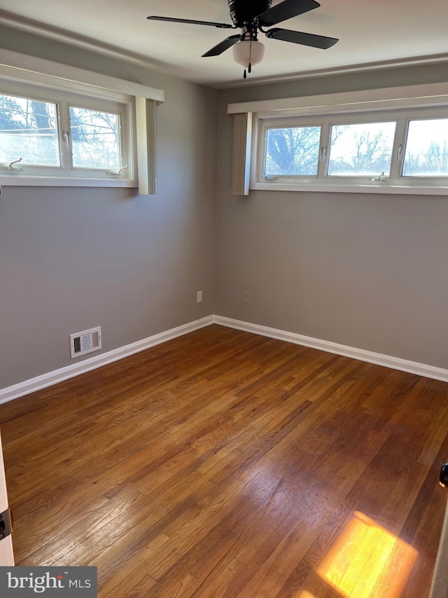 spare room with hardwood / wood-style floors, plenty of natural light, and ceiling fan