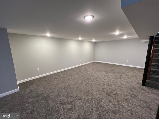 basement featuring dark colored carpet