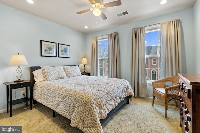 bedroom featuring recessed lighting, multiple windows, visible vents, and light colored carpet