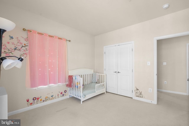 unfurnished bedroom with light carpet and a closet