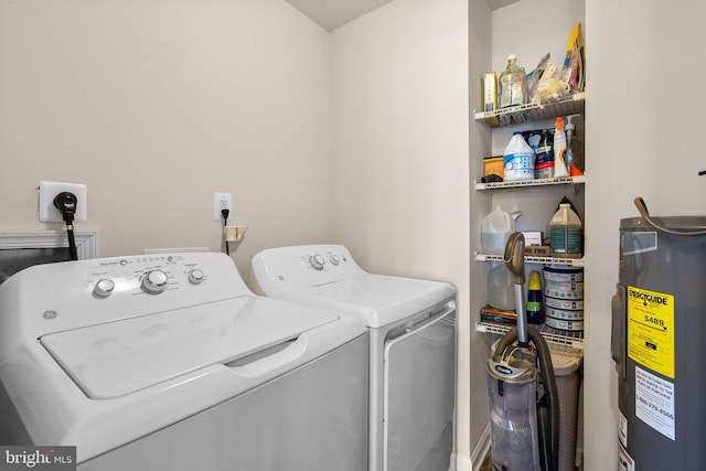 clothes washing area featuring water heater and separate washer and dryer