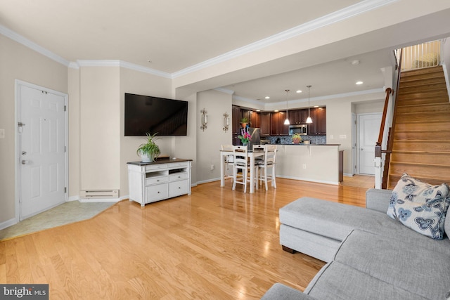 living room featuring crown molding and light hardwood / wood-style flooring