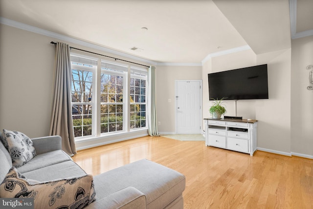 living room featuring ornamental molding and light hardwood / wood-style floors