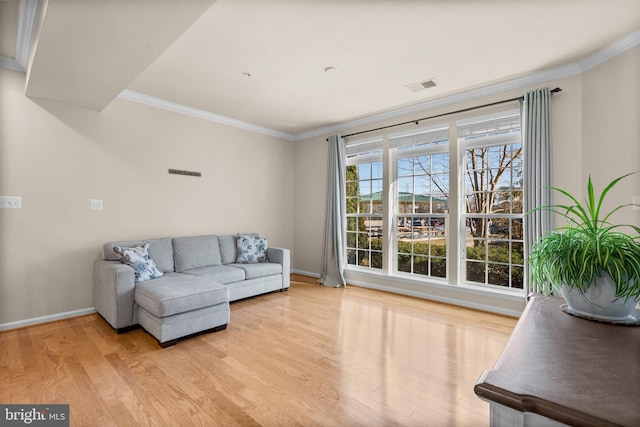 living room with light wood-type flooring and crown molding