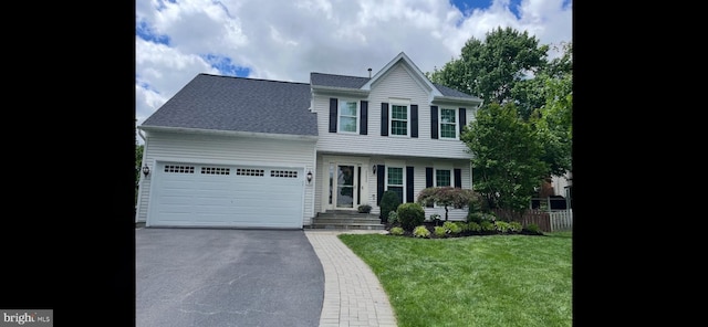 view of front of house featuring aphalt driveway, an attached garage, a shingled roof, fence, and a front yard