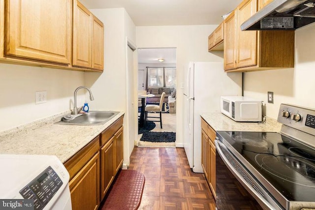 kitchen featuring white microwave, under cabinet range hood, a sink, stainless steel range with electric cooktop, and light countertops