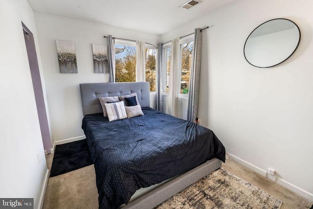 carpeted bedroom with baseboards and visible vents