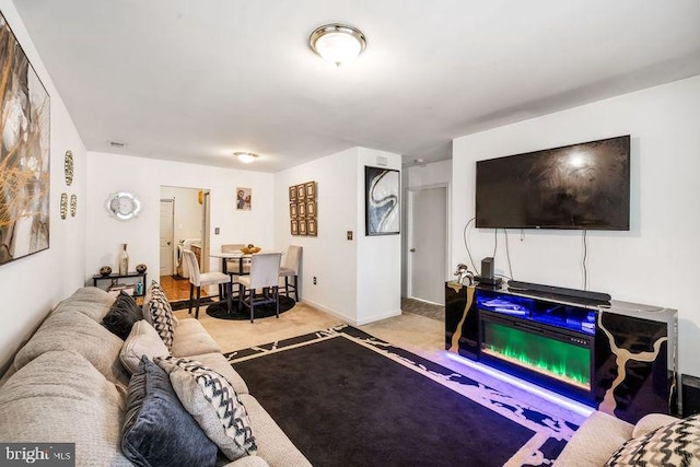 living room featuring light colored carpet and baseboards