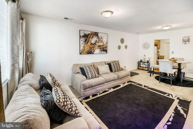 carpeted living room with visible vents