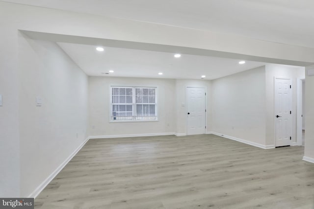 interior space with light wood-style flooring, baseboards, and recessed lighting