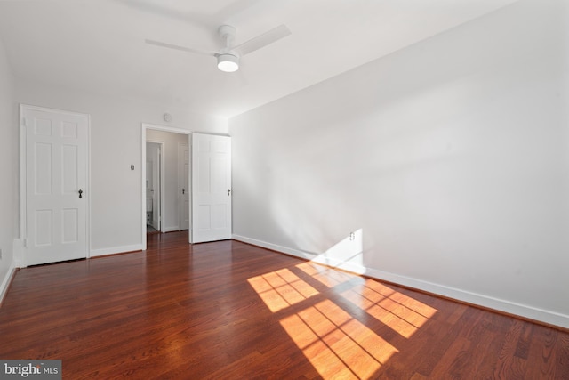 unfurnished bedroom with dark hardwood / wood-style flooring and ceiling fan