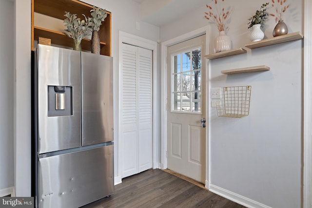 kitchen featuring stainless steel refrigerator with ice dispenser and dark wood-type flooring