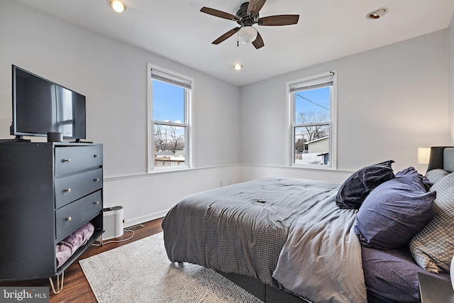 bedroom with ceiling fan and dark hardwood / wood-style flooring