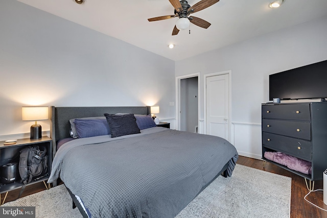 bedroom featuring ceiling fan, dark hardwood / wood-style flooring, and a closet