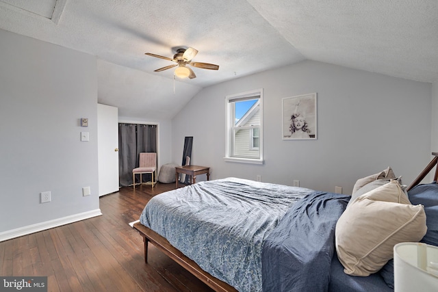 bedroom featuring vaulted ceiling, ceiling fan, a textured ceiling, and dark hardwood / wood-style flooring