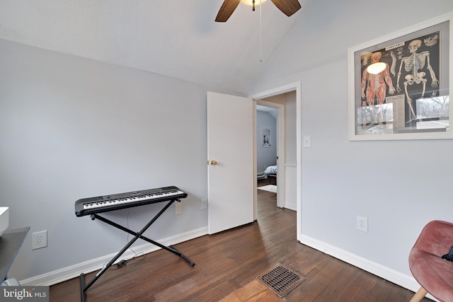 interior space with lofted ceiling, dark hardwood / wood-style floors, and ceiling fan