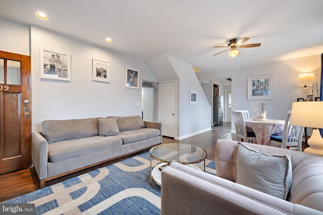 living room with dark hardwood / wood-style floors and ceiling fan