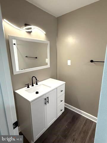 bathroom featuring hardwood / wood-style flooring and vanity