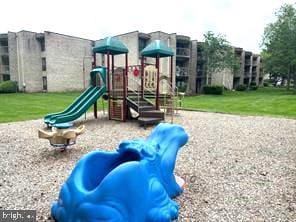 view of jungle gym featuring a lawn