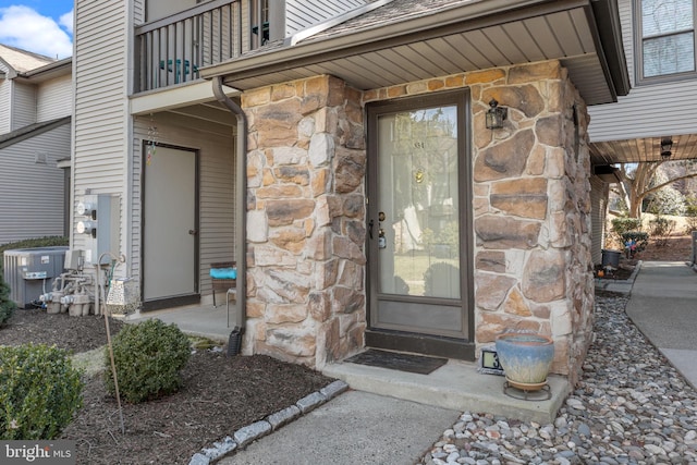 entrance to property featuring central AC unit and a balcony