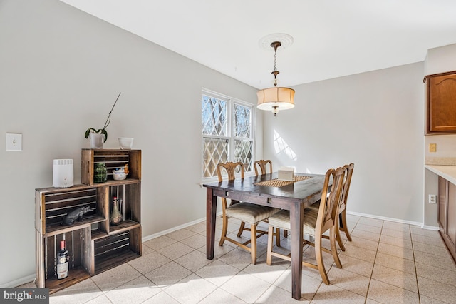 dining room featuring light tile patterned floors and baseboards