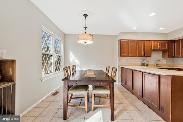 dining room with light tile patterned floors, recessed lighting, and baseboards