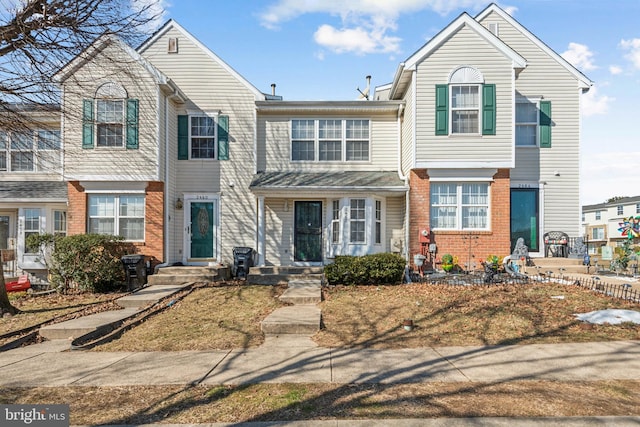 townhome / multi-family property with brick siding