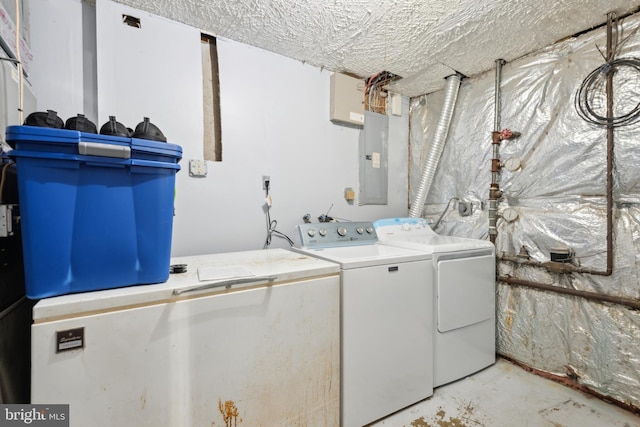 laundry room with laundry area, electric panel, and washer and dryer