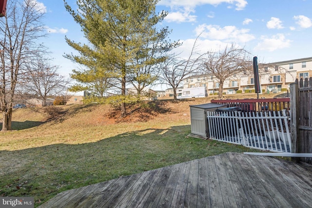 view of yard featuring a residential view and a deck