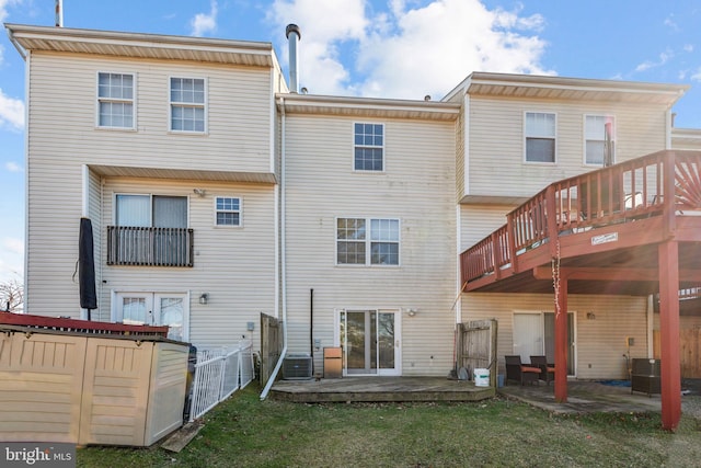 rear view of house featuring a yard, central AC unit, and a patio area