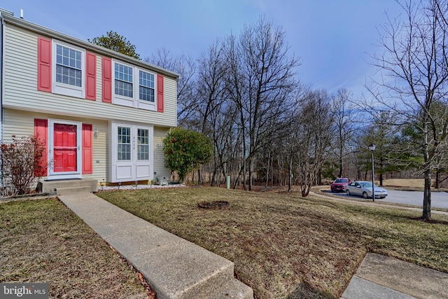 exterior space with french doors and a front lawn