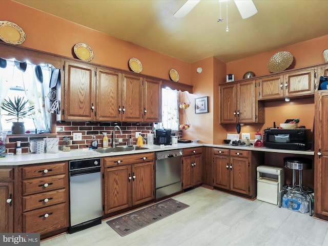 kitchen featuring tasteful backsplash, dishwasher, light wood-type flooring, ceiling fan, and sink