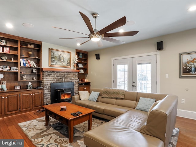 living room featuring light hardwood / wood-style flooring, ceiling fan, and french doors