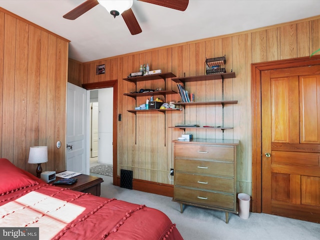 carpeted bedroom with wood walls